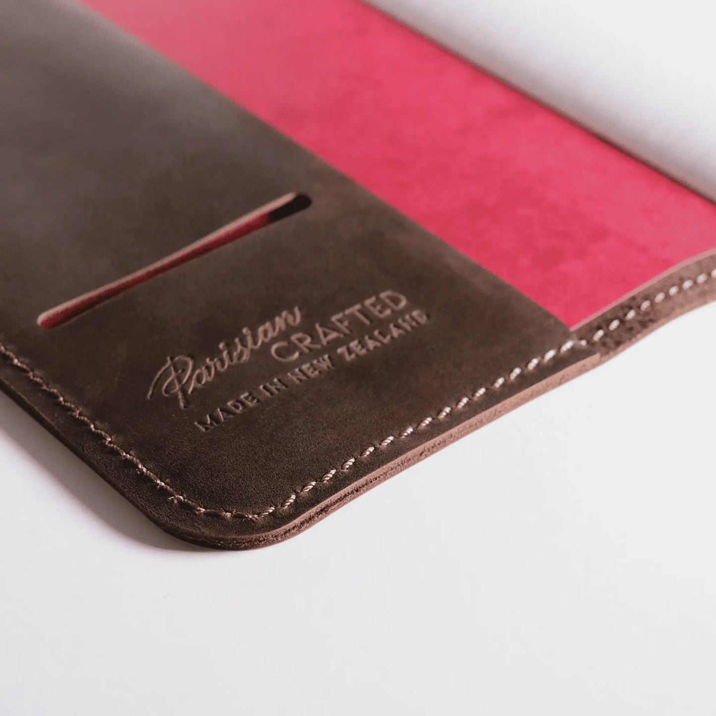 Close-up of the interior of an A5 brown leather notebook, featuring embossed Parisian Crafted branding and a red interior cover—a genuine leather journal with timeless style and quality craftsmanship.