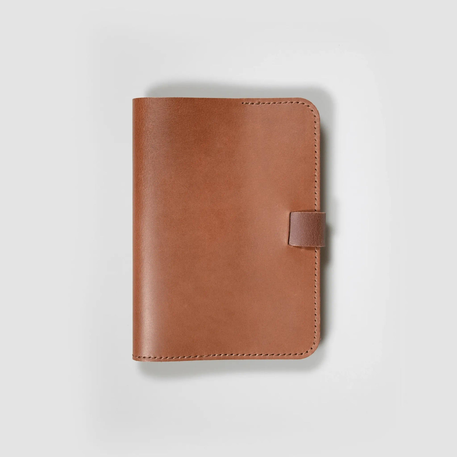 A5 tan leather notebook made locally in New Zealand, featuring crafted simplicity with refined stitching and timeless style. Small batch design with tab closure—stylish everyday stationery for men.