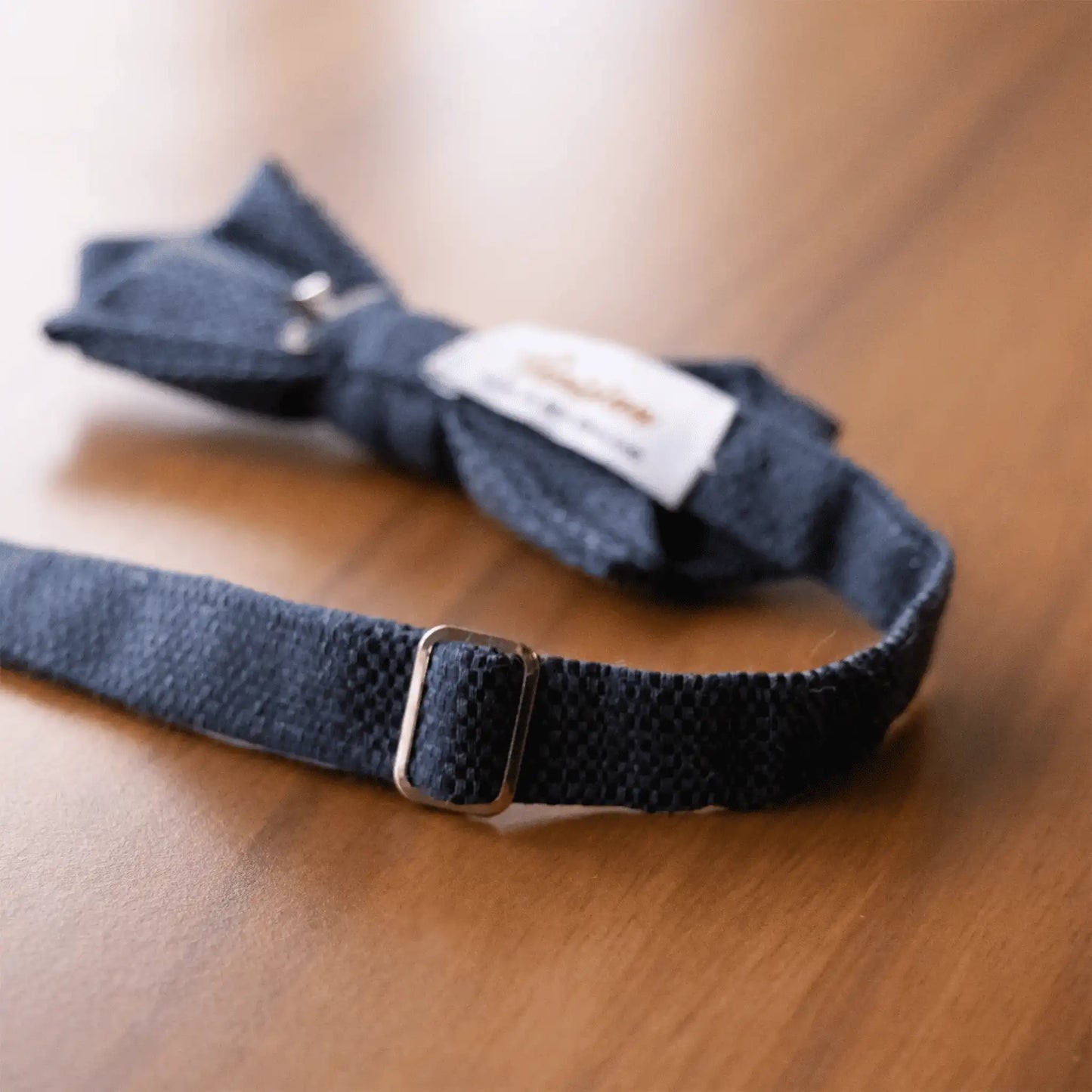 Sleek hardware detail on the Micro Squares Bow Tie collection, highlighting premium craftsmanship—sophisticated men's formal accessory.