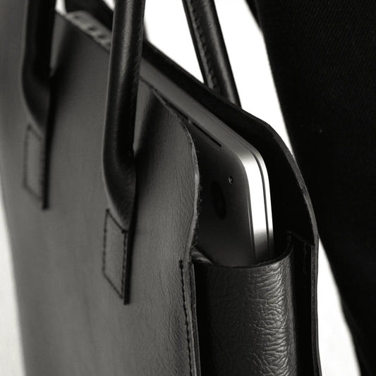 Detail of Premium Black Leather Business Tote with visible device, showcasing pocket design, fine-grain leather texture, and NZ craftsmanship.