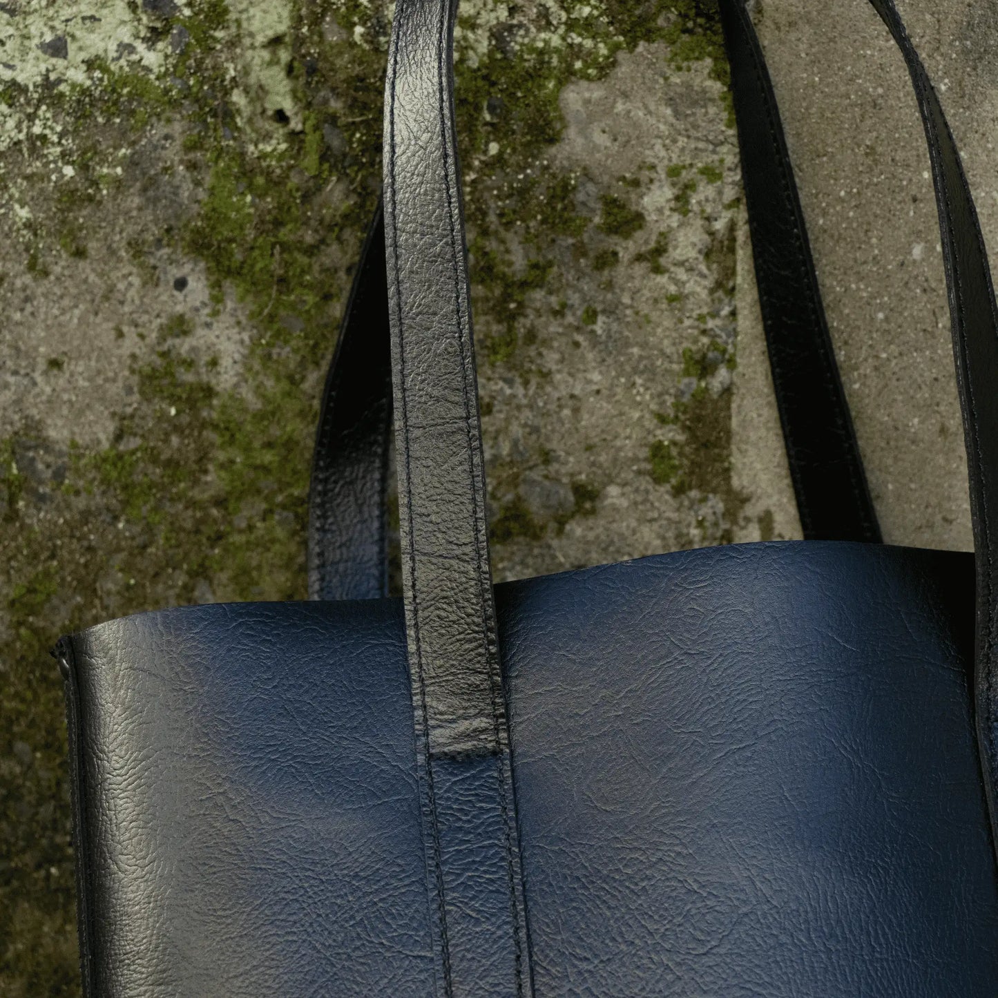 Close-up of the strap on the Everyday Black Leather Tote, showcasing detailed stitching and rustic leather finishes.