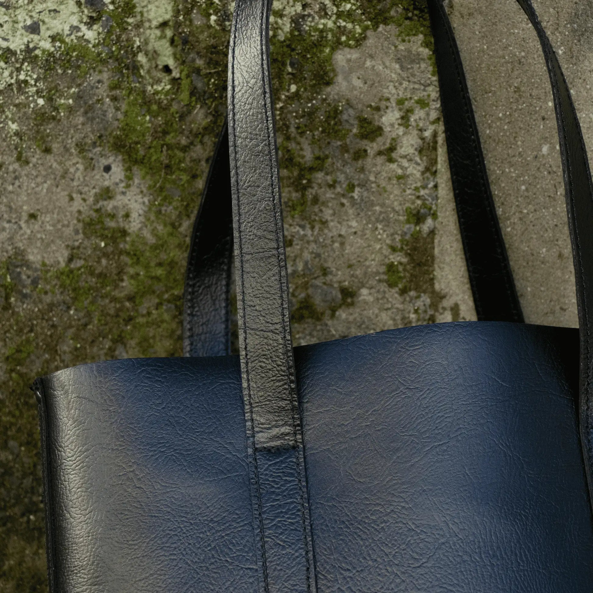 Close-up of the strap on the Everyday Black Leather Tote, showcasing detailed stitching and rustic leather finishes.