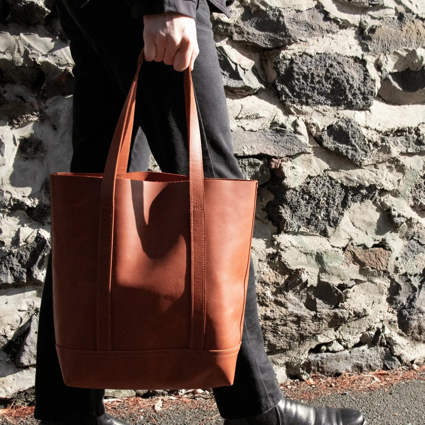 Gentleman walking with a Premium Tan Leather Everyday Tote - expertly crafted in New Zealand