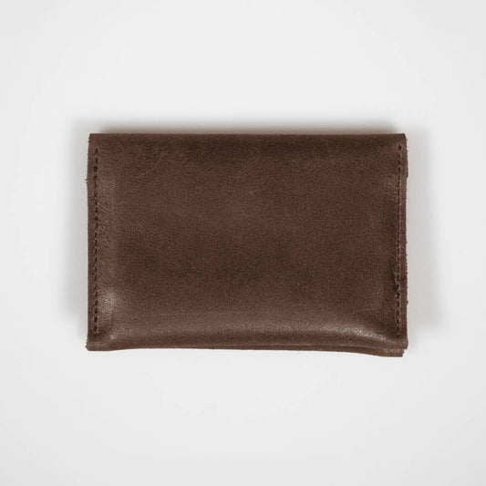 Brown leather folded card wallet on a white background, highlighting its premium leather and sleek, minimalist design.