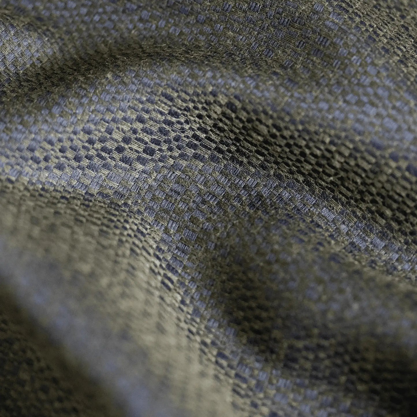Close-up of a cotton blend jacquard fabric in olive green and navy blue showing the detail and shine of the material used to make ties.