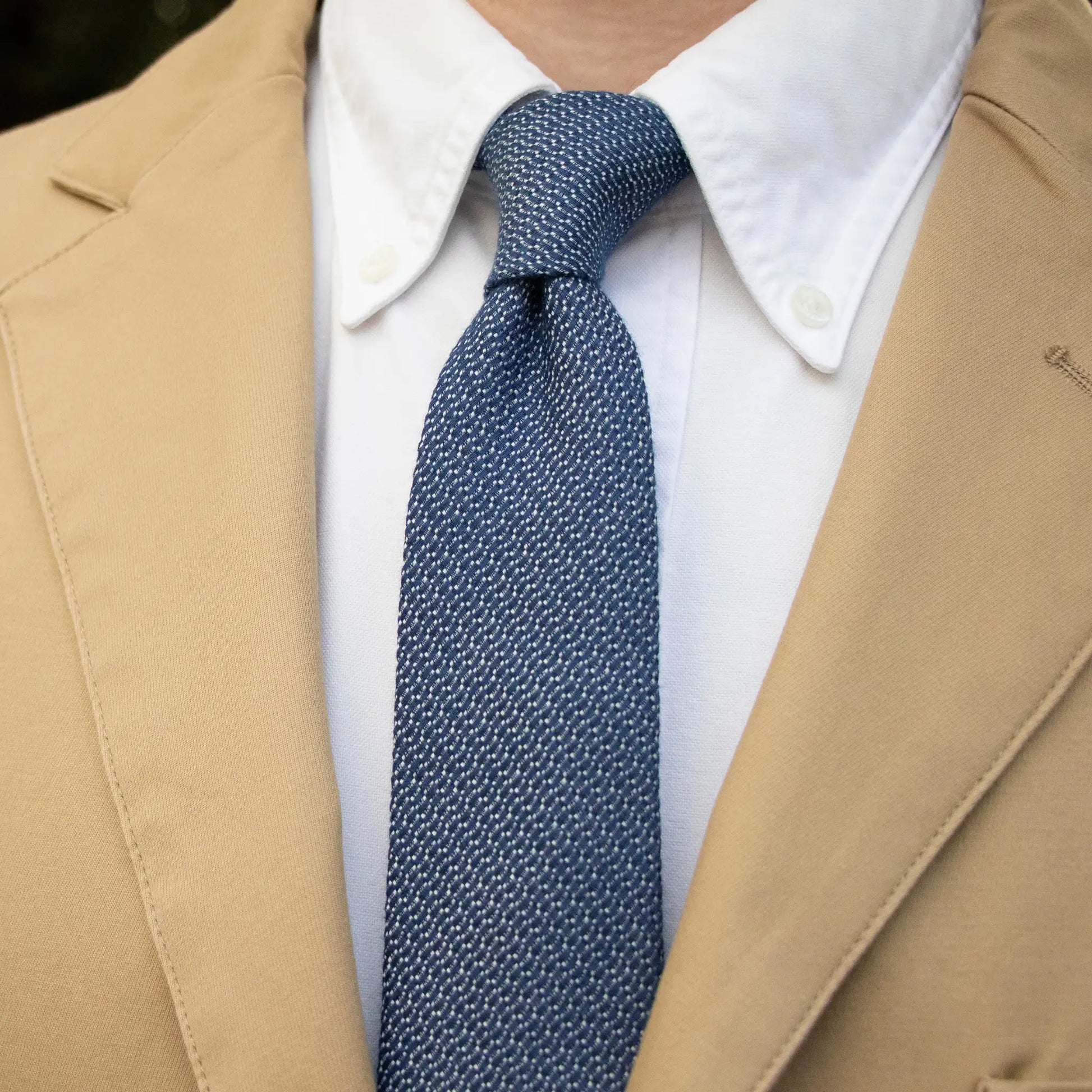 Mid blue and white Jacquard pattern cotton tie—made from high-quality cotton in New Zealand, paired with a tan blazer.