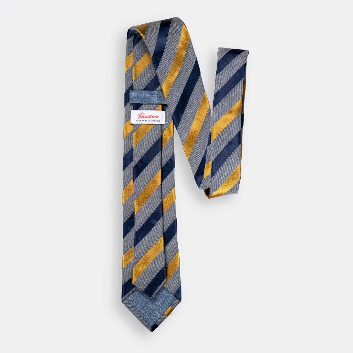 Back of the grey marle cotton/wool blend tie with navy and gold satin stripes, showcasing 'Parisian Made in New Zealand' woven label.