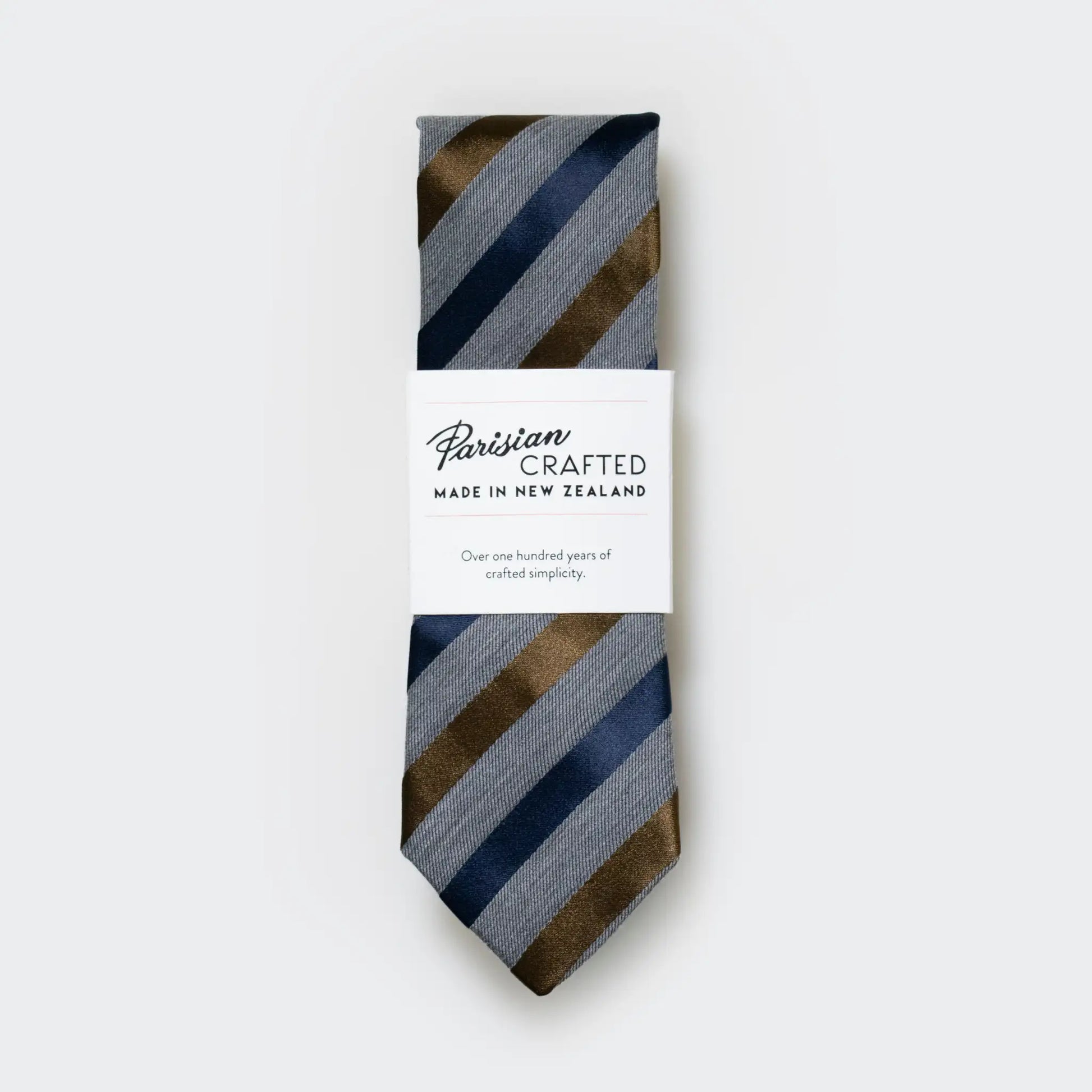 Grey marle men's tie with navy and tobacco satin stripes, packaged into Parisian Crafted's signature white sleeve with bold logo.