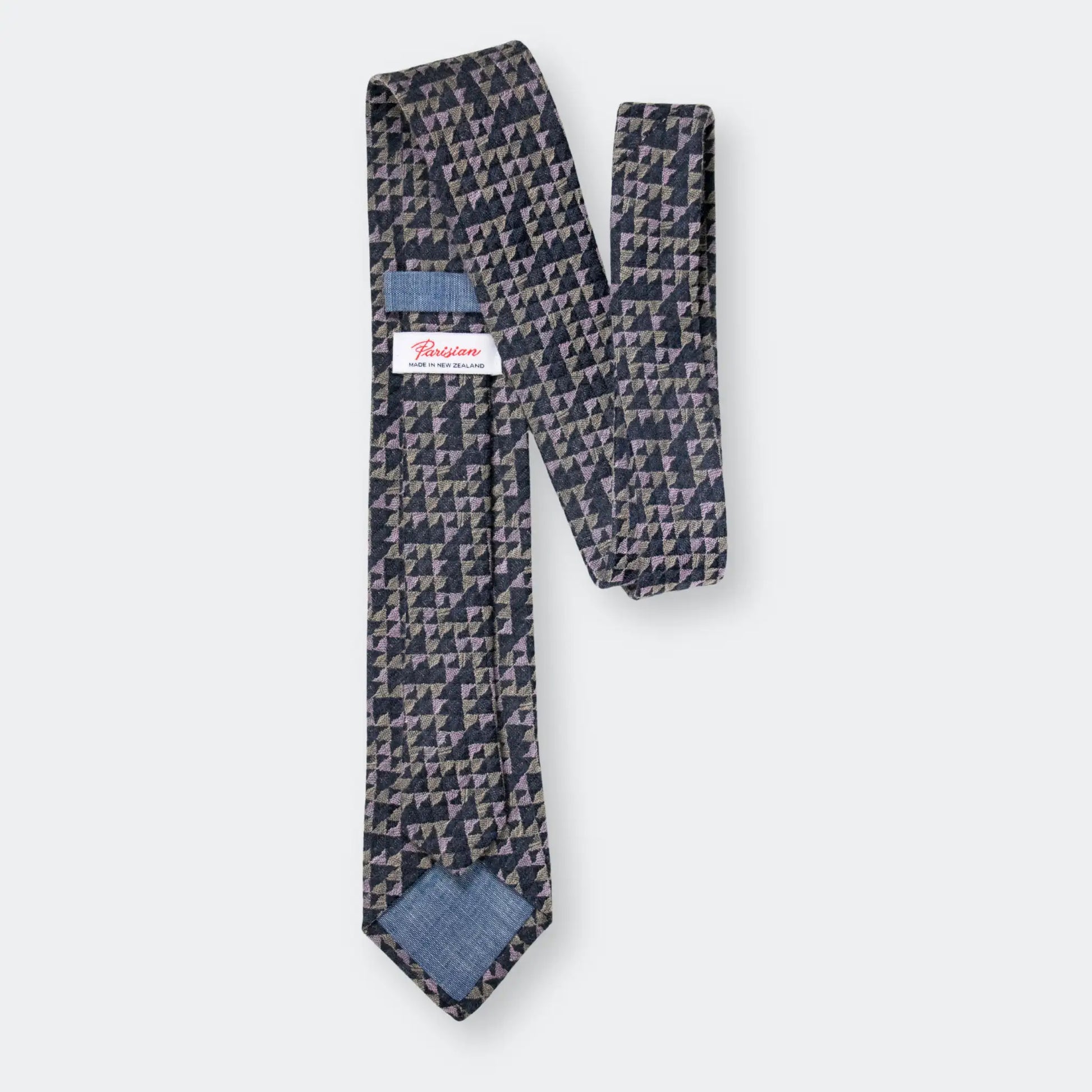 Back of sage, pink and charcoal tie with intricate geometric pattern, displaying the 'Parisian Made in New Zealand' woven label.