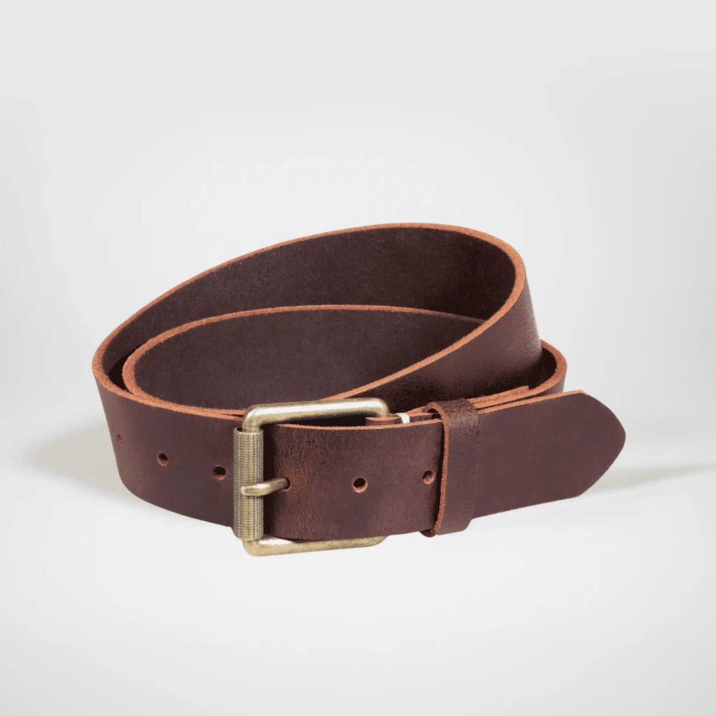 Mocha-brown Leather work belt rolled on white surface, with brass buckle.