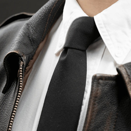 Pure Black Worsted Wool Tie paired with a leather jacket and white button-down shirt - classic Parisian Crafted essentials.