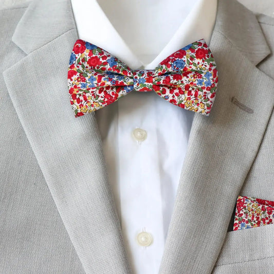Floral bow tie and pocket square from Liberty London on a gray suit jacket