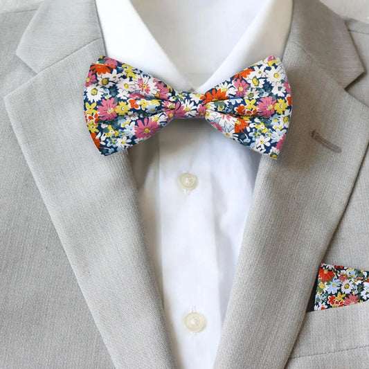 Liberty London floral bow tie and pocket square on a gray suit jacket