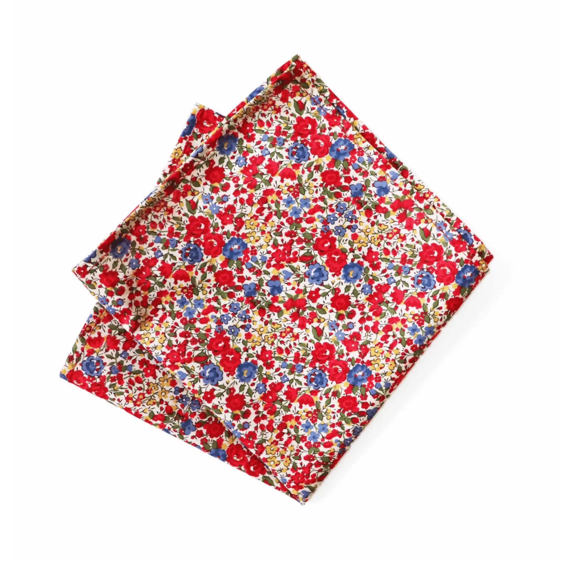 Liberty London’s Emma & Georgina Tana Lawn fabric pocket square, featuring vibrant red and blue floral print on a cream background. Parisian Crafted x Liberty collaboration for timeless menswear styling.