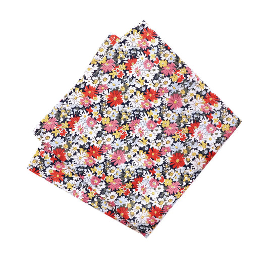 Liberty London’s Libby Tana Lawn fabric pocket square featuring vibrant daisy print. Parisian Crafted x Liberty collaboration with a colorful floral design—eye-catching accessory for sophisticated menswear.