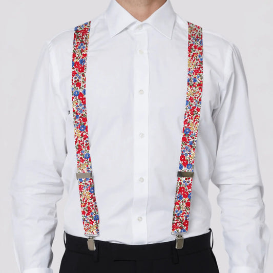 person wearing a white shirt with colorful Liberty London suspenders on a white background