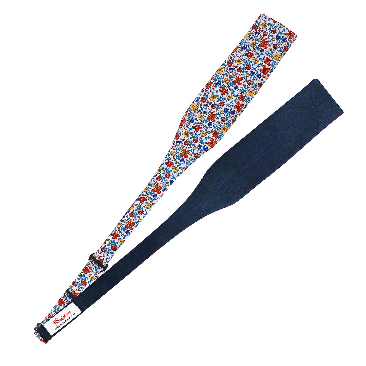 The Helena's Meadow Tie Your Own Bow lying on a white background showing the woven 'Parisian Made in New Zealand' label.