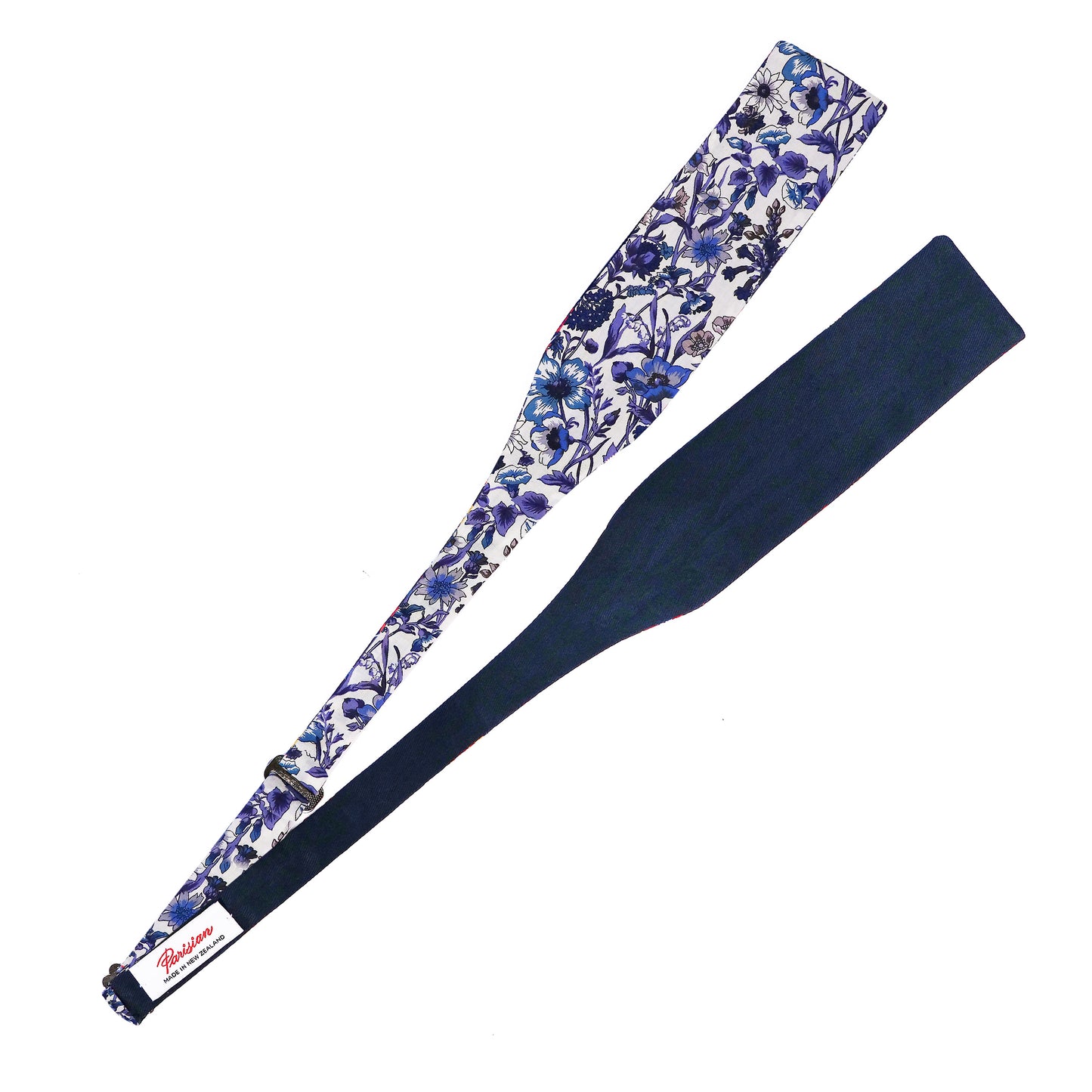 The Rachel Tie Your Own Bow lying on a white background showing the woven 'Parisian Made in New Zealand' Label.