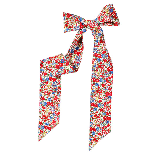 The Emma & Georgina Twilly tied in a bow sitting on a white background.