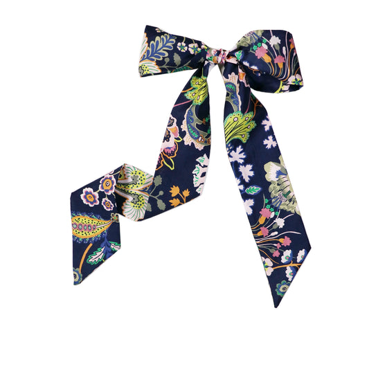 The Symphony Twilly tied into a bow on a white background.