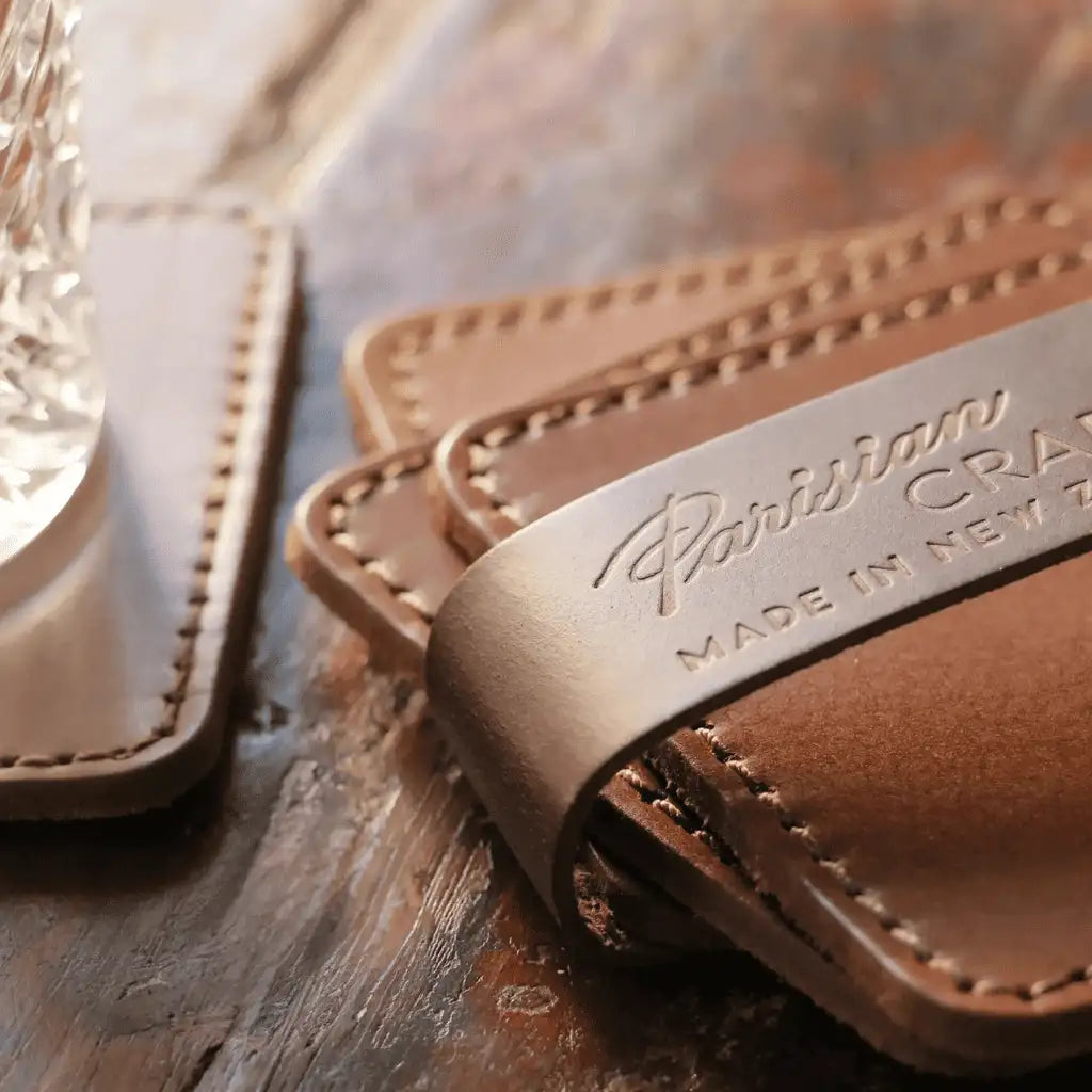 Close-up of Parisian Crafted leather drinks coasters with embossed logo
