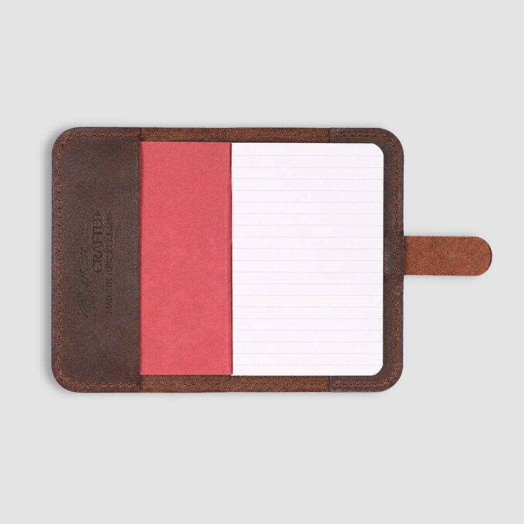Small A6 leather notepad with notebook on a white background