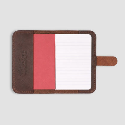 Small A6 leather notepad with notebook on a white background