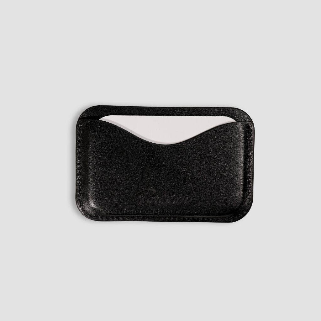 Black leather cardholder with a Parisian branding on a white background