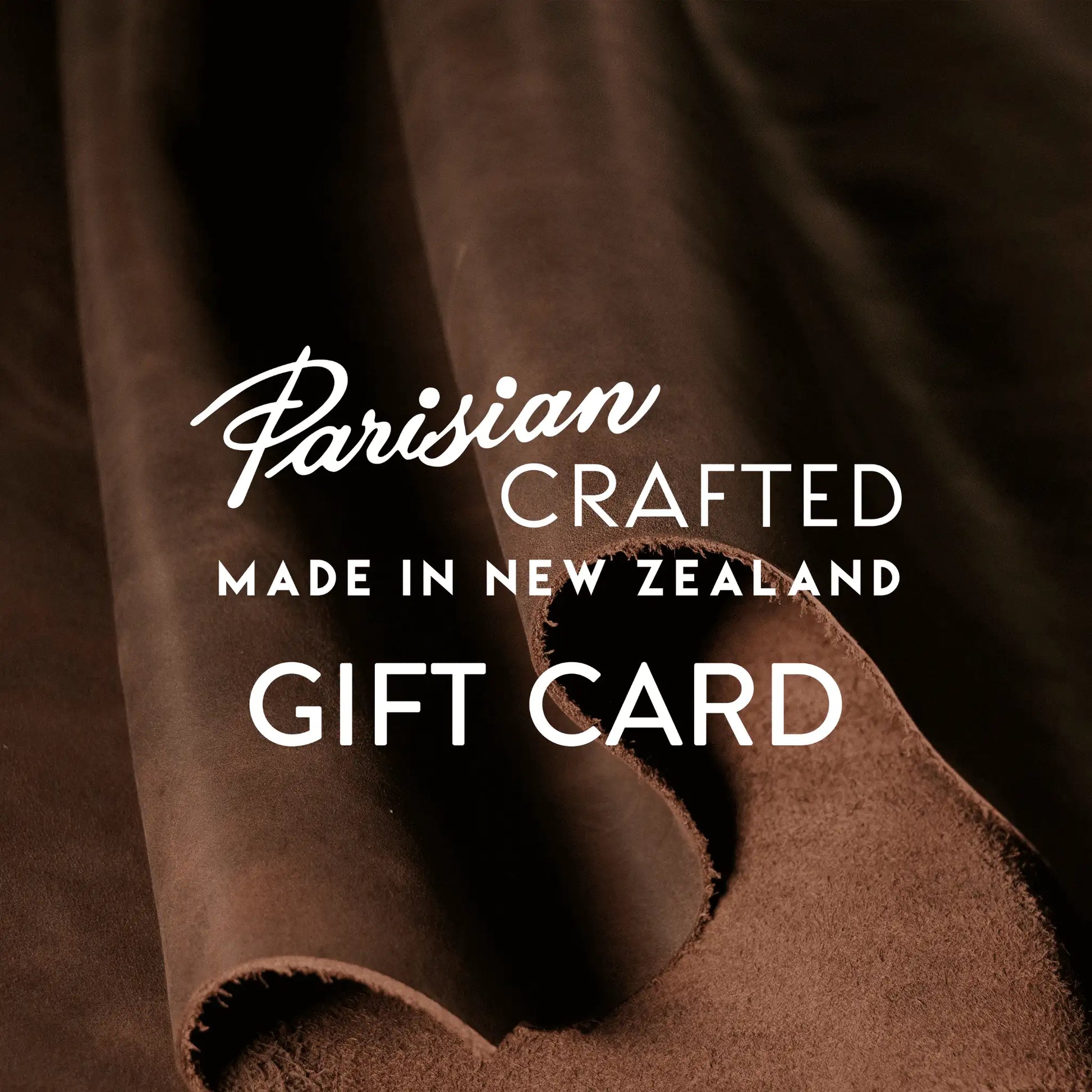 Brown leather rolled in the background behind Parisian Crafted logo and Gift Card text