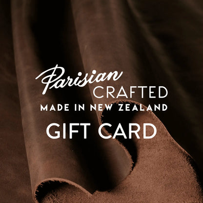 Brown leather rolled in the background behind Parisian Crafted logo and Gift Card text