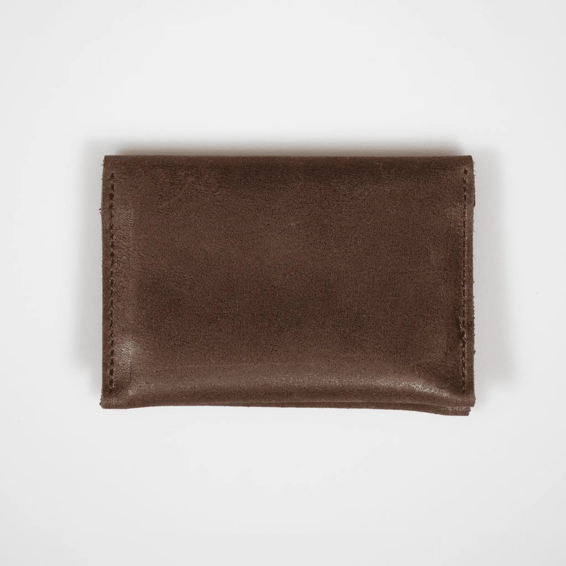 Brown leather folded card wallet on a white background, highlighting its premium leather and sleek, minimalist design.