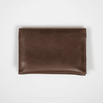 Brown leather folded card wallet on a white background, highlighting its premium leather and sleek, minimalist design.