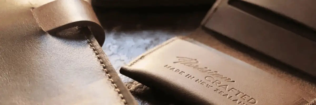 Banner image of embossed leather wallet and edge of leather notebook
