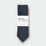 the Denim White Rust Pin Dot Tie on a white background with white card Parisian packaging