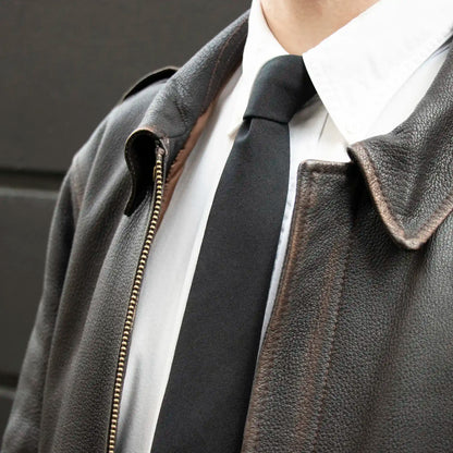 The Pure Black Worsted Wool Tie worn with a Leather Jacket and a White Button Down Shirt