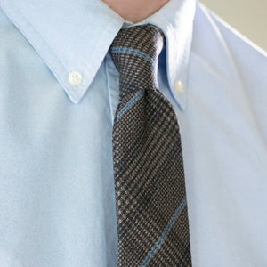 A close up of the Slate Blue Check Tie worn with a Soft Blue Button Down Shirt.