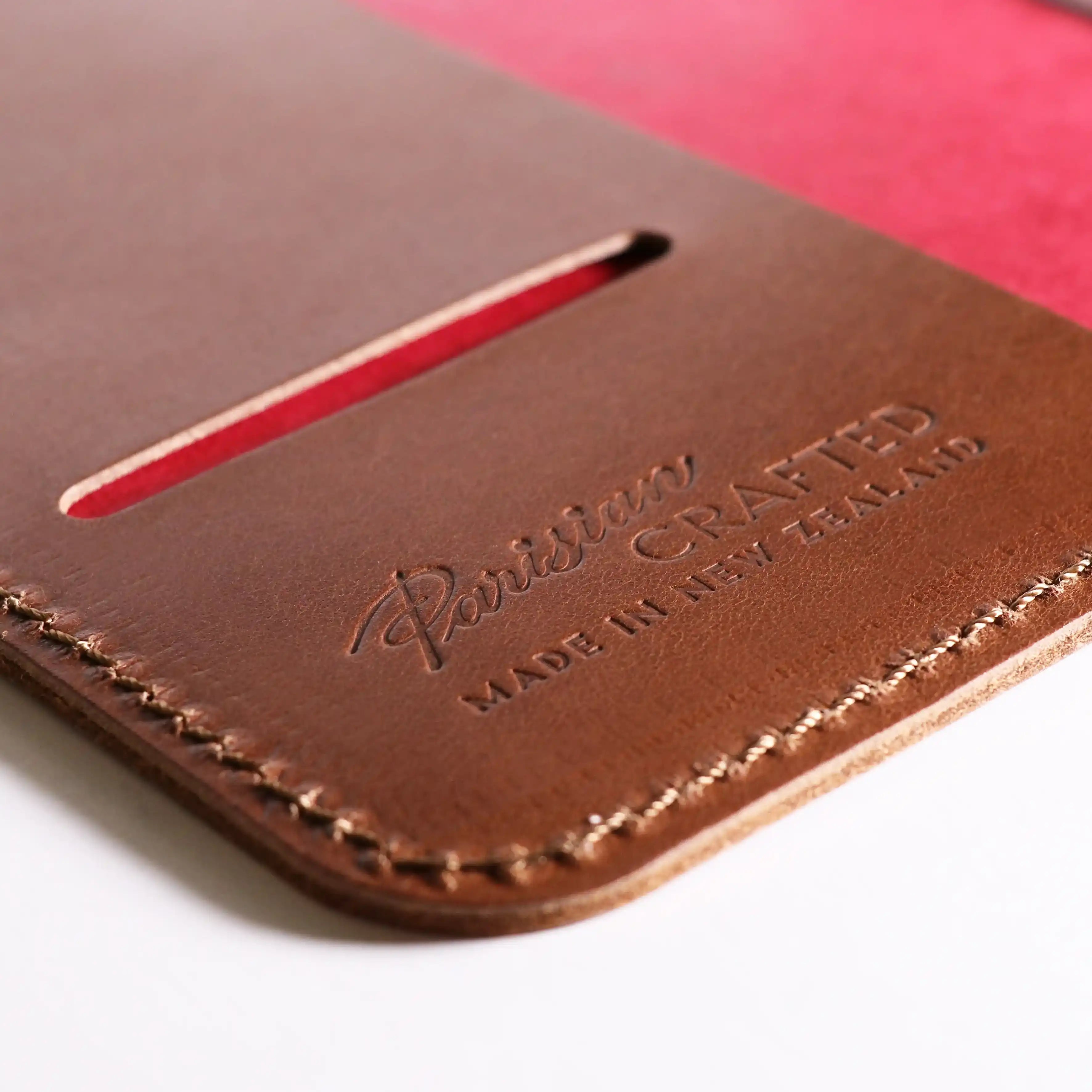  A close up of the embossed Parisian logo on the inside of the Cognac Leather Notebook.