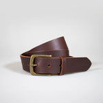 The Brown Everyday Classic Leather Belt with Brass hardware rolled up on a white background.