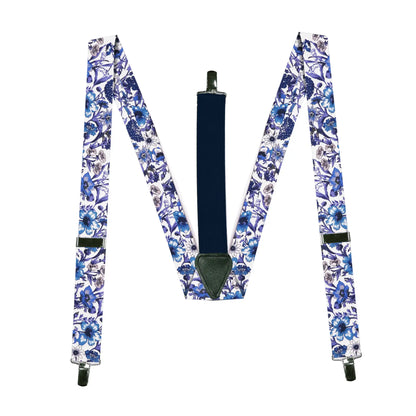 Blue purple and white braces with a floral pattern from a collaborative Parisian and Liberty London collection, lying flat on a white background.