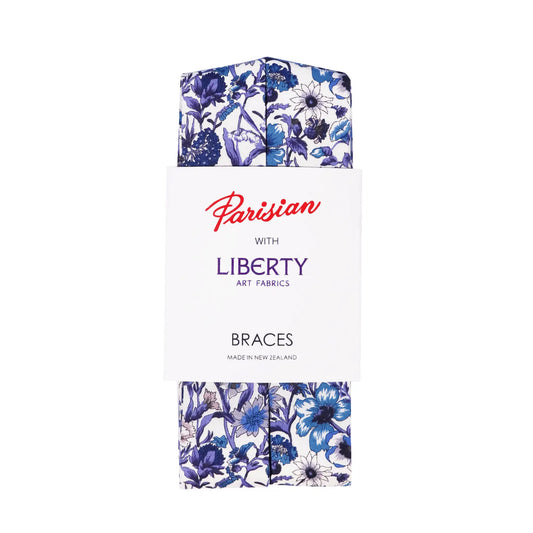 Blue purple and white braces with a floral pattern folded into Parisian with Liberty packaging on a white background.