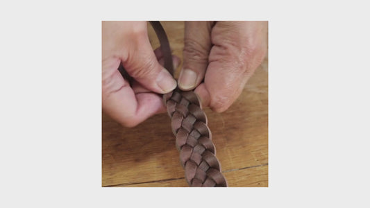 A detail  of the Brown Hand-Woven Leather Belt being hand woven.