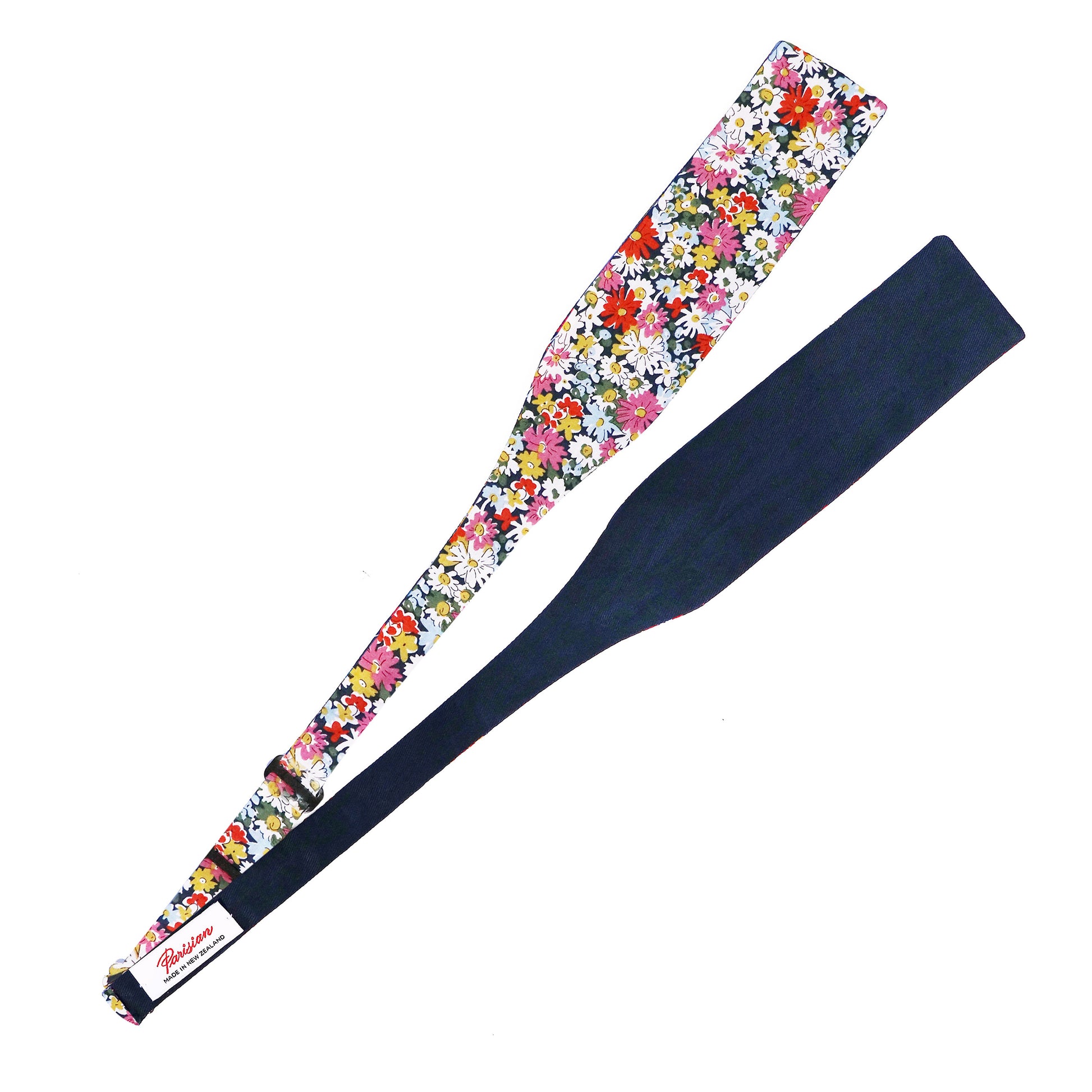 The Libby Tie Your Own Bow lying on a white background showing the woven 'Parisian Made in New Zealand' label.