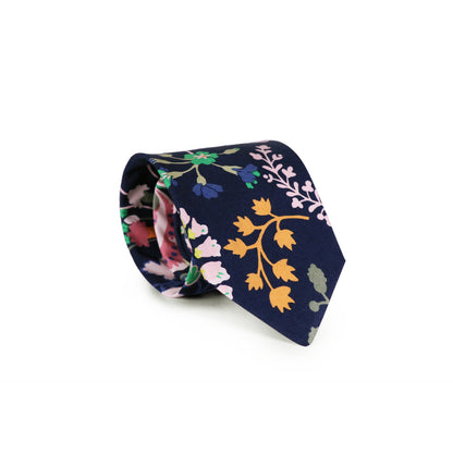 The Symphony Tie rolled up on a white background.